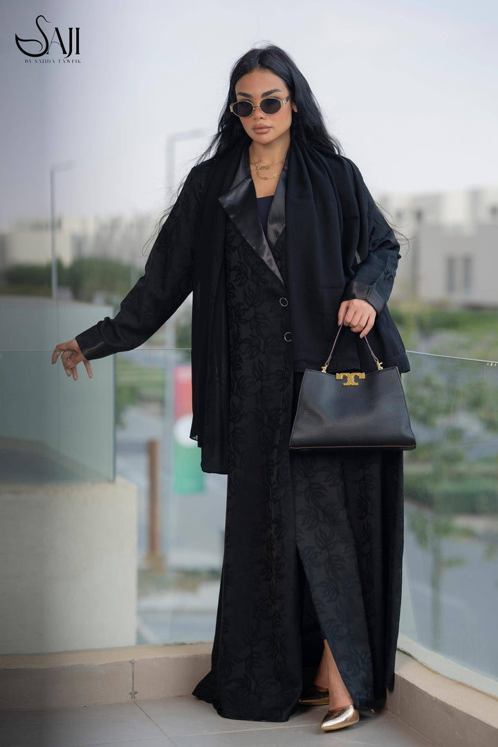 Tala Jacquard Abaya in elegant Korean design, featuring intricate patterns and satin details. A luxurious black traditional outfit for all occasions.